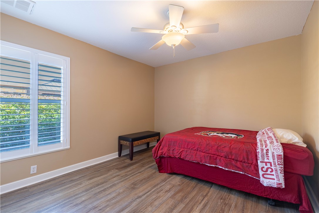 152 35th Square Southwest Vero Beach, FL 32968 - Photo 18 of 35 a bedroom with a bed and a chandelier
