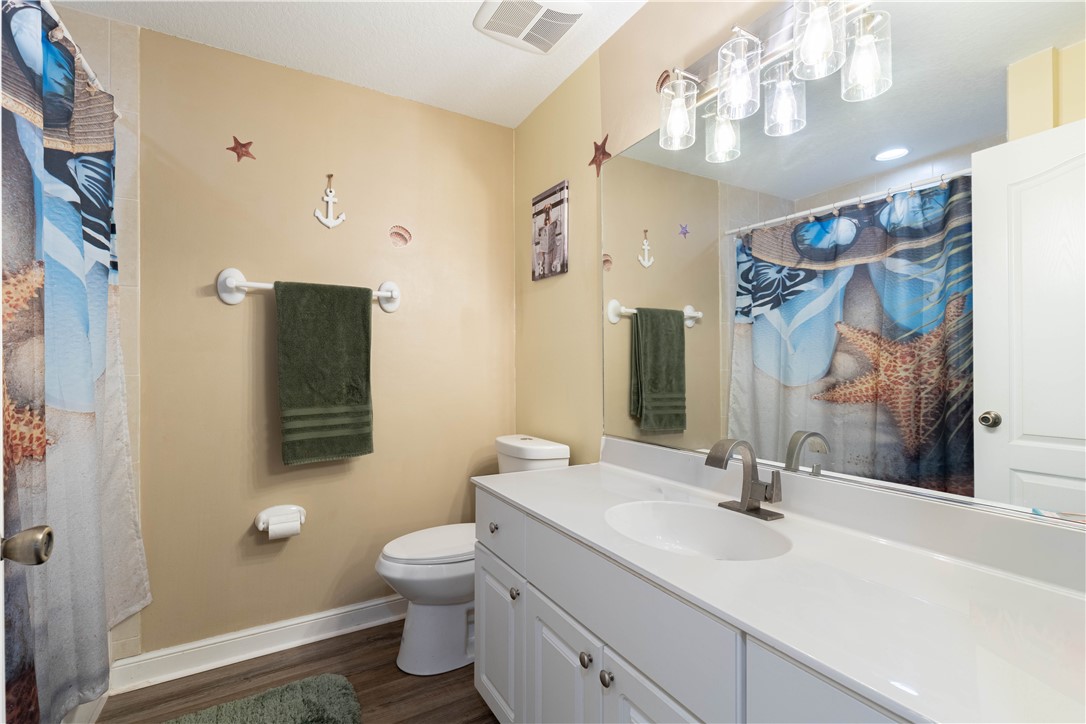 152 35th Square Southwest Vero Beach, FL 32968 - Photo 19 of 35 a bathroom with a toilet sink and mirror