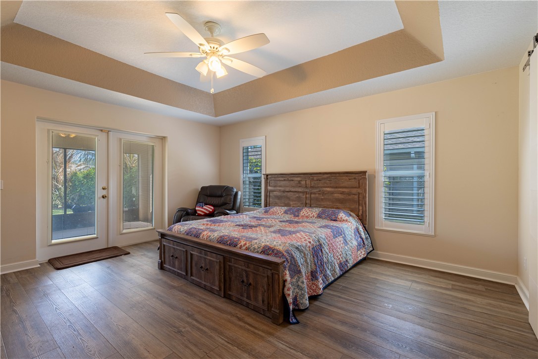 152 35th Square Southwest Vero Beach, FL 32968 - Photo 21 of 35 a bedroom with a large bed and a chandelier