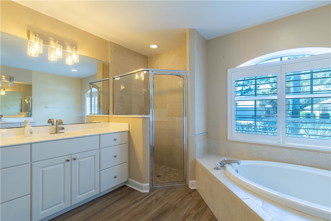 152 35th Square Southwest Vero Beach, FL 32968 - Photo 24 of 35 a bathroom with a tub a sink and mirrors