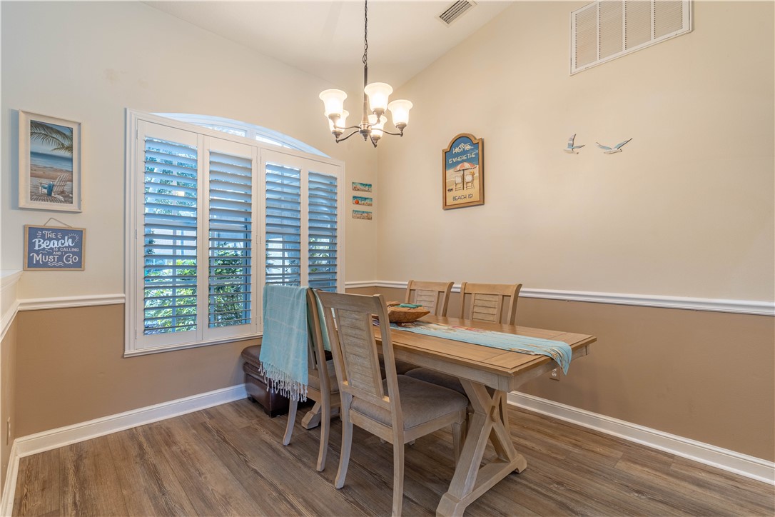 152 35th Square Southwest Vero Beach, FL 32968 - Photo 7 of 35 a view of a dining room with furniture window and wooden floor