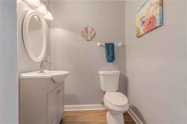 a bathroom with a toilet a sink and a mirror