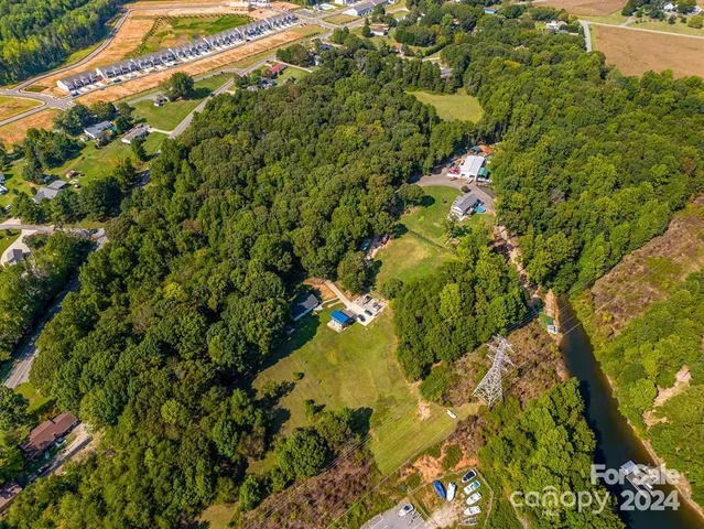 an aerial view of a house with a lake view