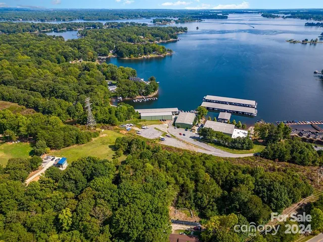 an aerial view of house with yard and ocean view