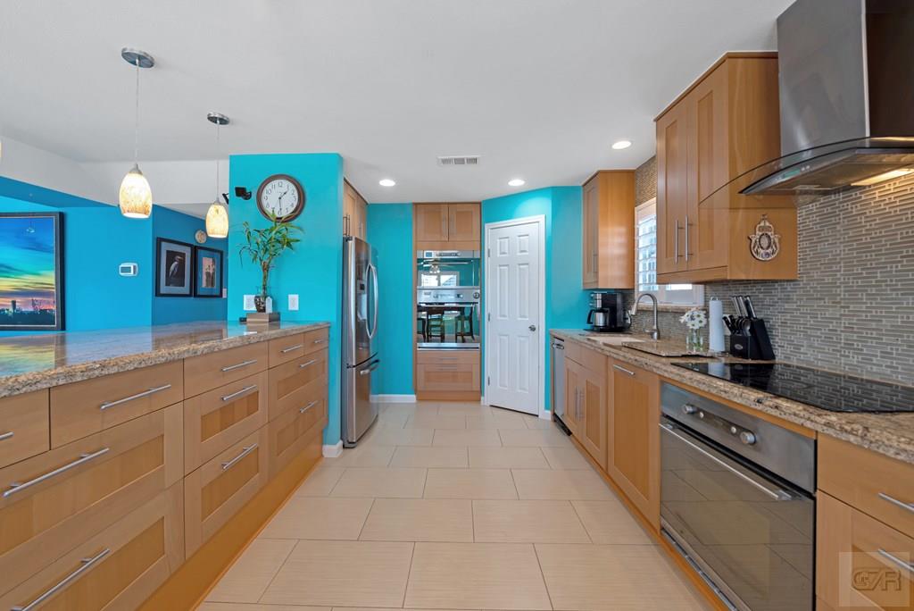 270 Isles End Road Tiki Island, TX 77554 - Photo 12 of 49 a large kitchen with stainless steel appliances granite countertop a sink and a stove