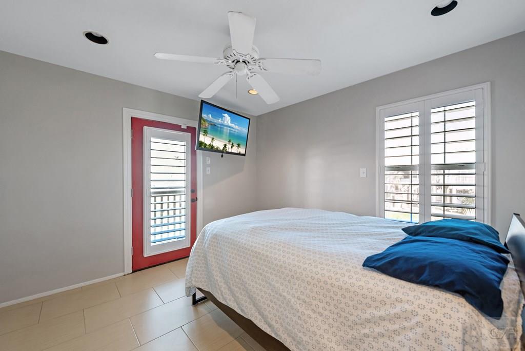 270 Isles End Road Tiki Island, TX 77554 - Photo 20 of 49 a bedroom with a bed and a window