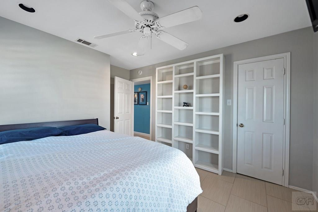 270 Isles End Road Tiki Island, TX 77554 - Photo 21 of 49 a bedroom with a large bed and window