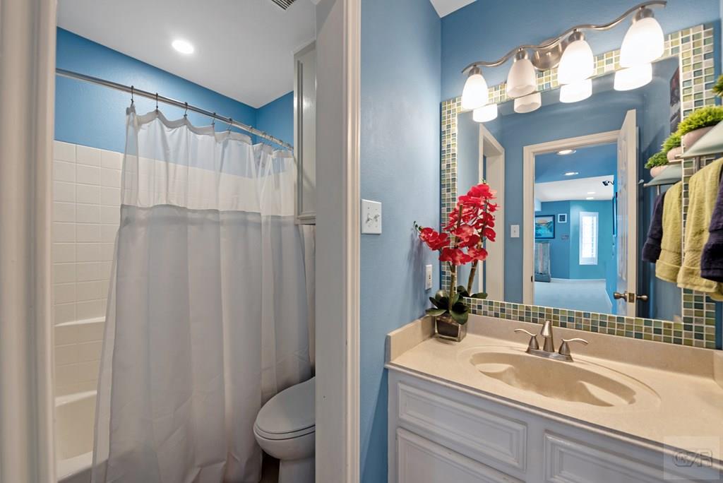 270 Isles End Road Tiki Island, TX 77554 - Photo 22 of 49 a bathroom with a sink vanity mirror and toilet