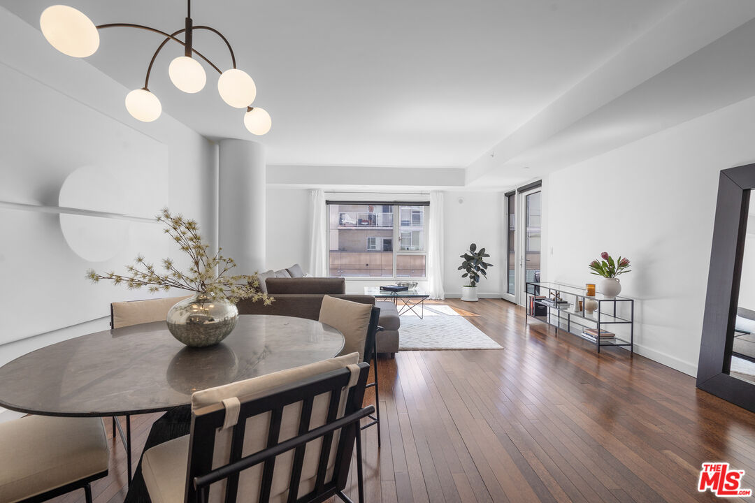 6250 Hollywood Boulevard, Unit 7K Los Angeles, CA 90028 - Photo 1 of 50 a view of a dining room with furniture wooden floor and chandelier