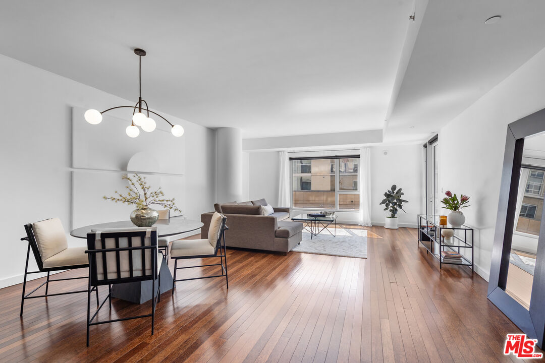 6250 Hollywood Boulevard, Unit 7K Los Angeles, CA 90028 - Photo 3 of 50 a view of a dining room with furniture window and wooden floor