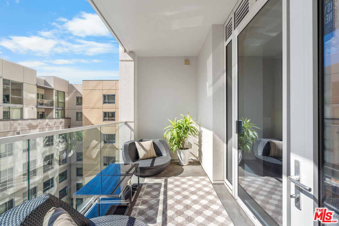 6250 Hollywood Boulevard, Unit 7K Los Angeles, CA 90028 - Photo 33 of 50 a view of a balcony with chairs and a potted plant