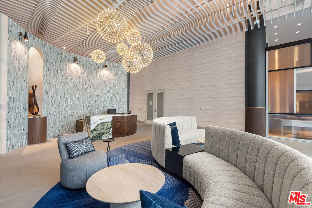 6250 Hollywood Boulevard, Unit 7K Los Angeles, CA 90028 - Photo 47 of 50 a living room with furniture a large window and wooden floor