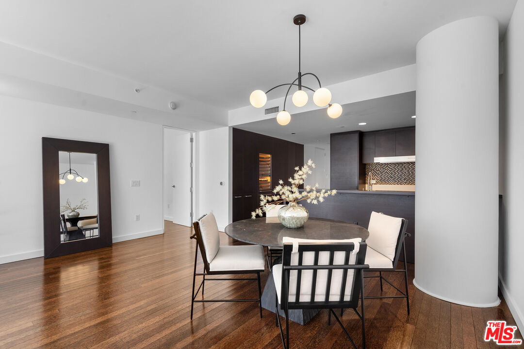 6250 Hollywood Boulevard, Unit 7K Los Angeles, CA 90028 - Photo 6 of 50 a view of a dining room with furniture wooden floor and chandelier
