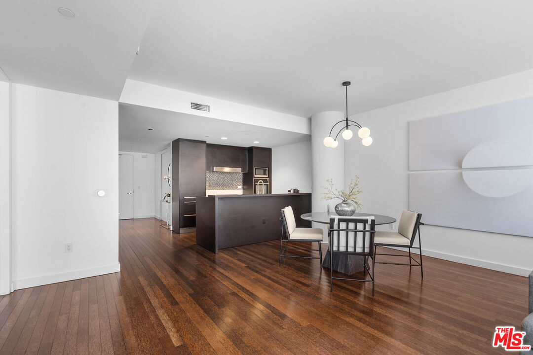 6250 Hollywood Boulevard, Unit 7K Los Angeles, CA 90028 - Photo 10 of 50 a view of a dining room with furniture and wooden floor