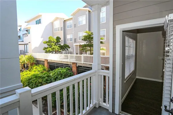 a view of a balcony with flower plants