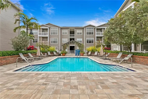a view of a house with swimming pool and sitting area
