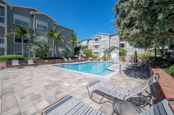 a view of a house with backyard and sitting area