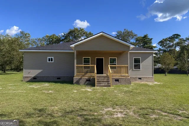 a front view of a house with a garden