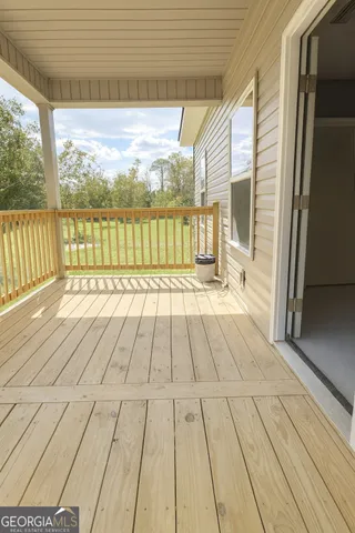 a view of balcony with wooden floor