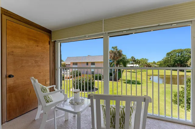 a view of a chair and table in the balcony