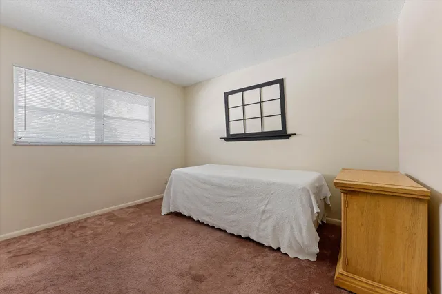 a bedroom with a bed and cabinets