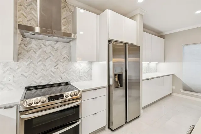 a kitchen with cabinets and stainless steel appliances