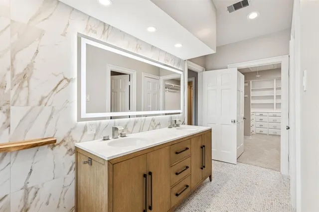 a bathroom with a sink double vanity and a mirror