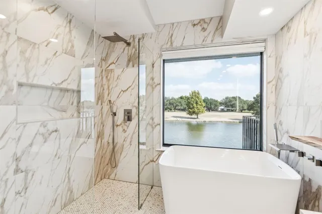 a bathroom with a bathtub and shower