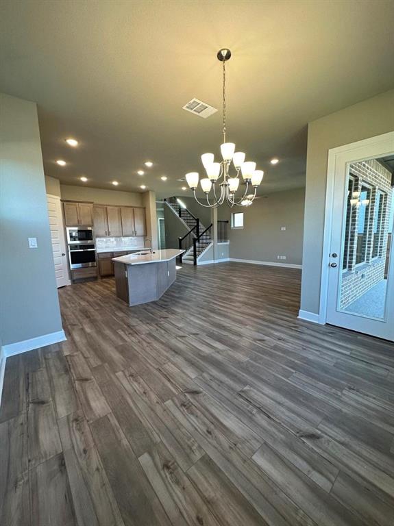 2525 Four Roses Drive Lewisville, TX 75056 - Photo 6 of 19 a view of a living room and chandelier in a room