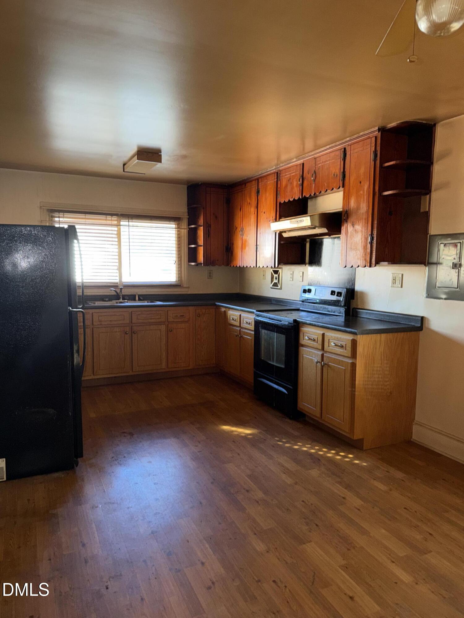404 Forbes Drive Smithfield, NC 27577 - Photo 3 of 11 a kitchen with stainless steel appliances granite countertop a sink and cabinets