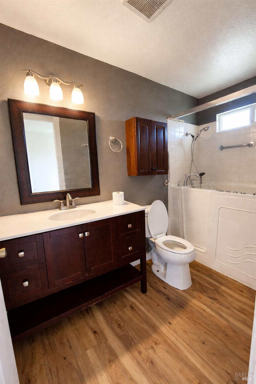717 Blair Place Santa Rosa, CA 95401 - Photo 12 of 23 a bathroom with a toilet a sink and mirror