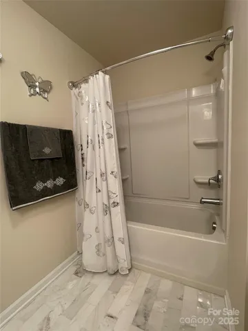 a bathroom with a shower and a bath tub