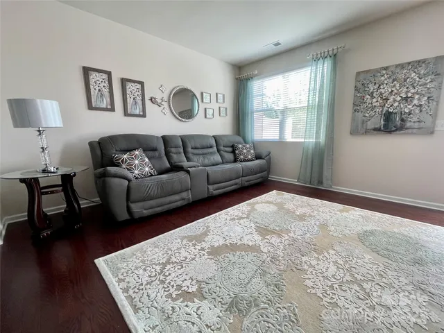 a living room with furniture window and wooden floor