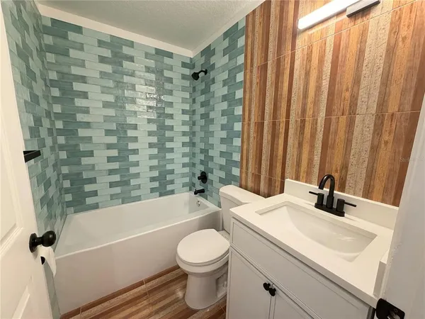 a bathroom with a sink a toilet and a bathtub