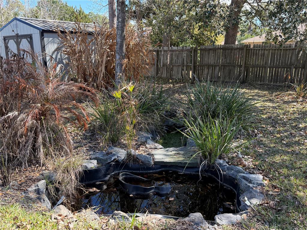 16 Powder Hill Lane Palm Coast, FL 32164 - Photo 20 of 27 a view of a backyard with wooden fence
