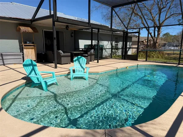a view of a chairs and table in the patio
