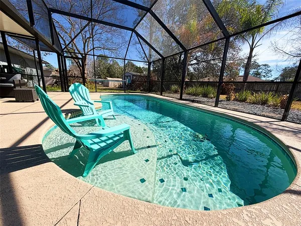 a view of a backyard with sitting area