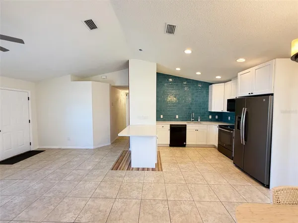 a open kitchen with refrigerator sink and cabinets