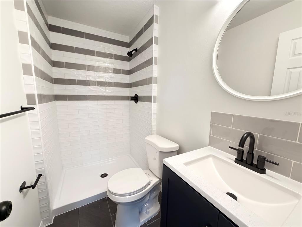 16 Powder Hill Lane Palm Coast, FL 32164 - Photo 9 of 27 a bathroom with a sink toilet and a mirror