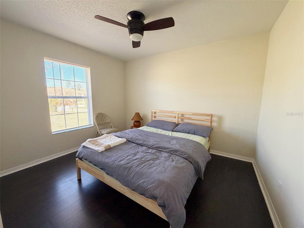 16 Powder Hill Lane Palm Coast, FL 32164 - Photo 10 of 27 a bedroom with a bed and wooden floor