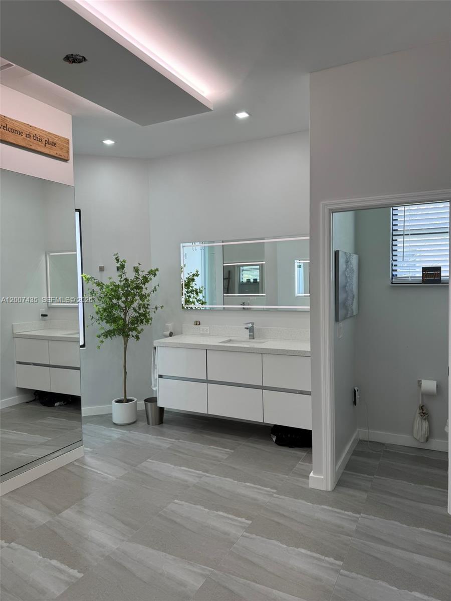 15053 Southwest 40th Street Davie, FL 33331 - Photo 19 of 36 Right side of Master bathroom. Light appears pink but it's not.