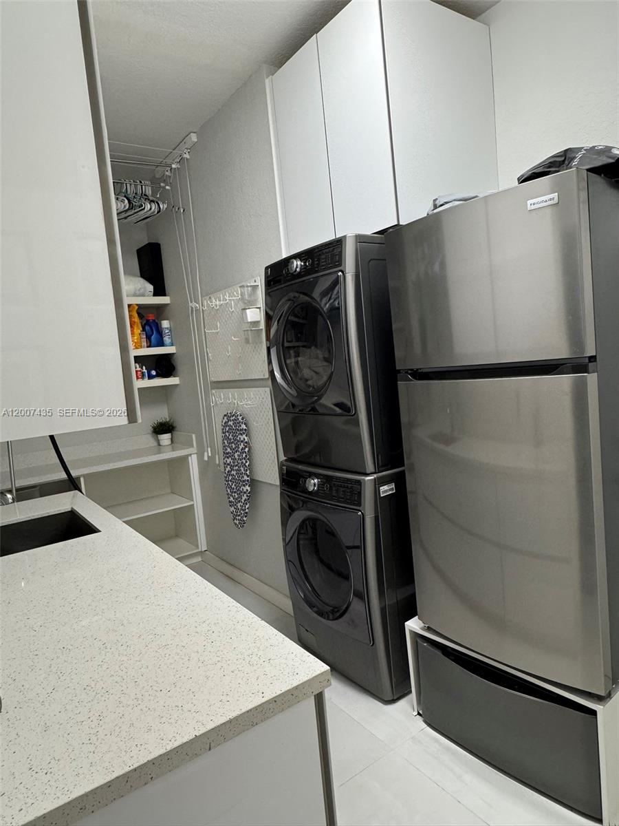 15053 Southwest 40th Street Davie, FL 33331 - Photo 30 of 36 Underneath the extra refrigerator is a small washing machine