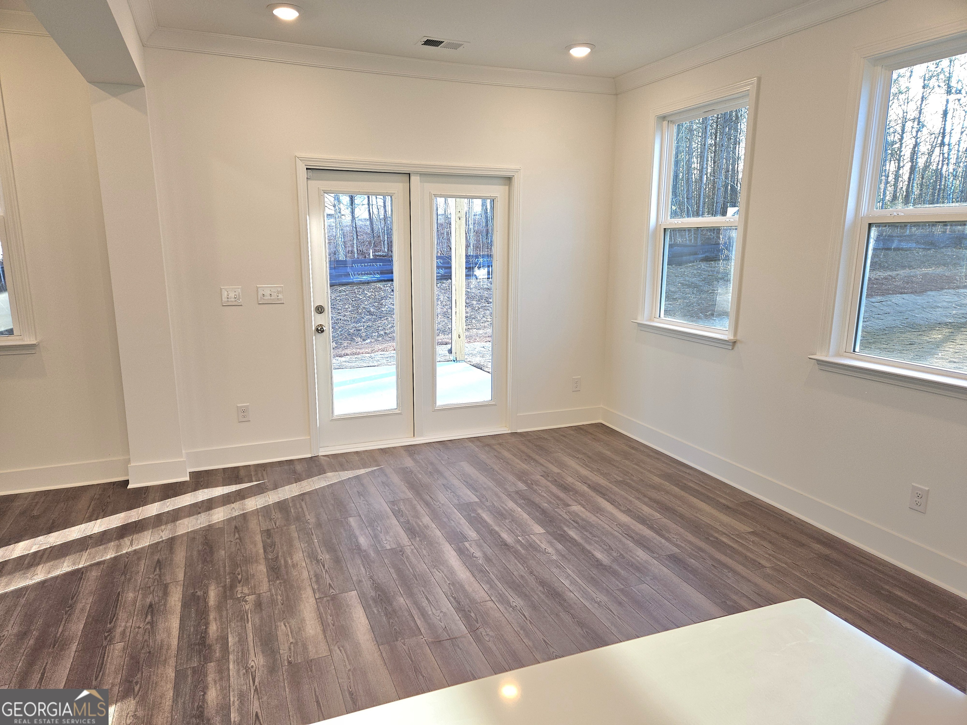 219 Andalusa Court Dallas, GA 30132 - Photo 16 of 50 a view of an empty room with wooden floor and a window