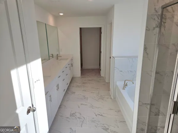 a bathroom with sink a mirror and a shower