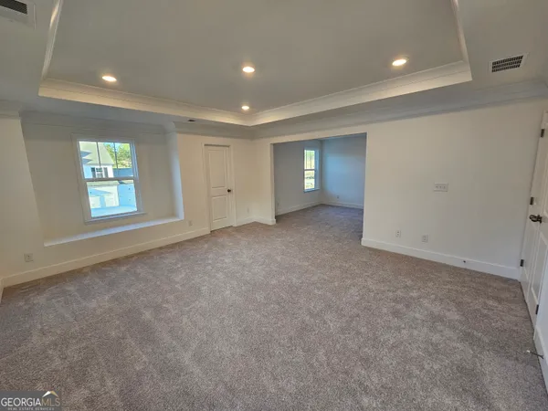 an empty room with windows and closet