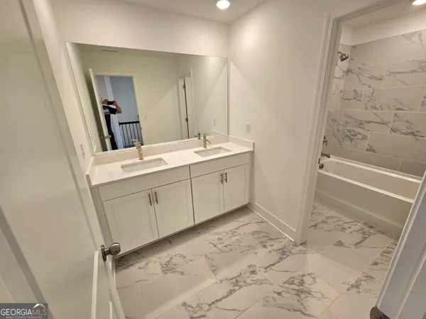 a bathroom with a bathtub and a shower