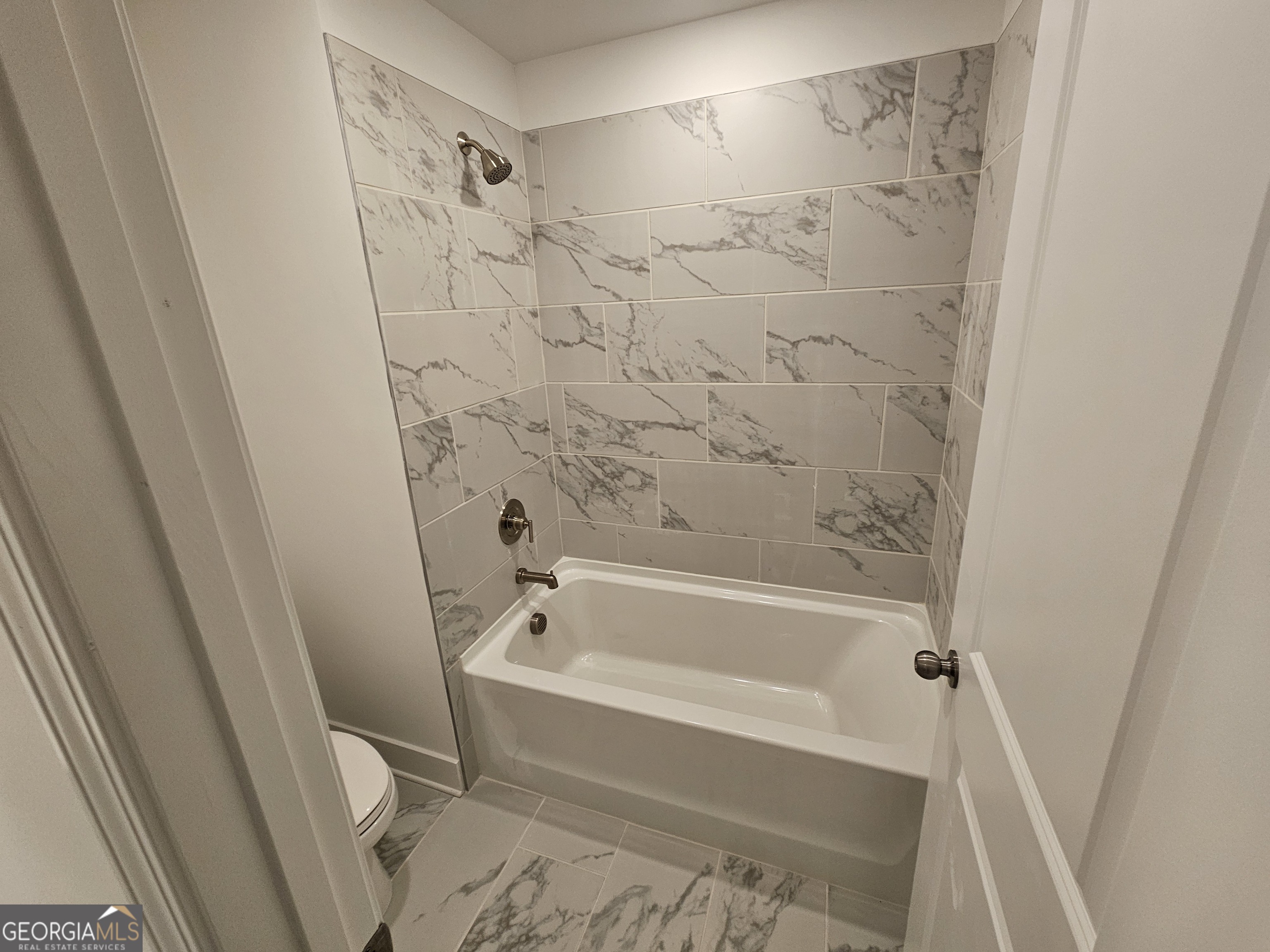 219 Andalusa Court Dallas, GA 30132 - Photo 46 of 50 a bathroom with a bathtub and a shower