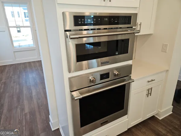 a stove top oven sitting inside of a kitchen