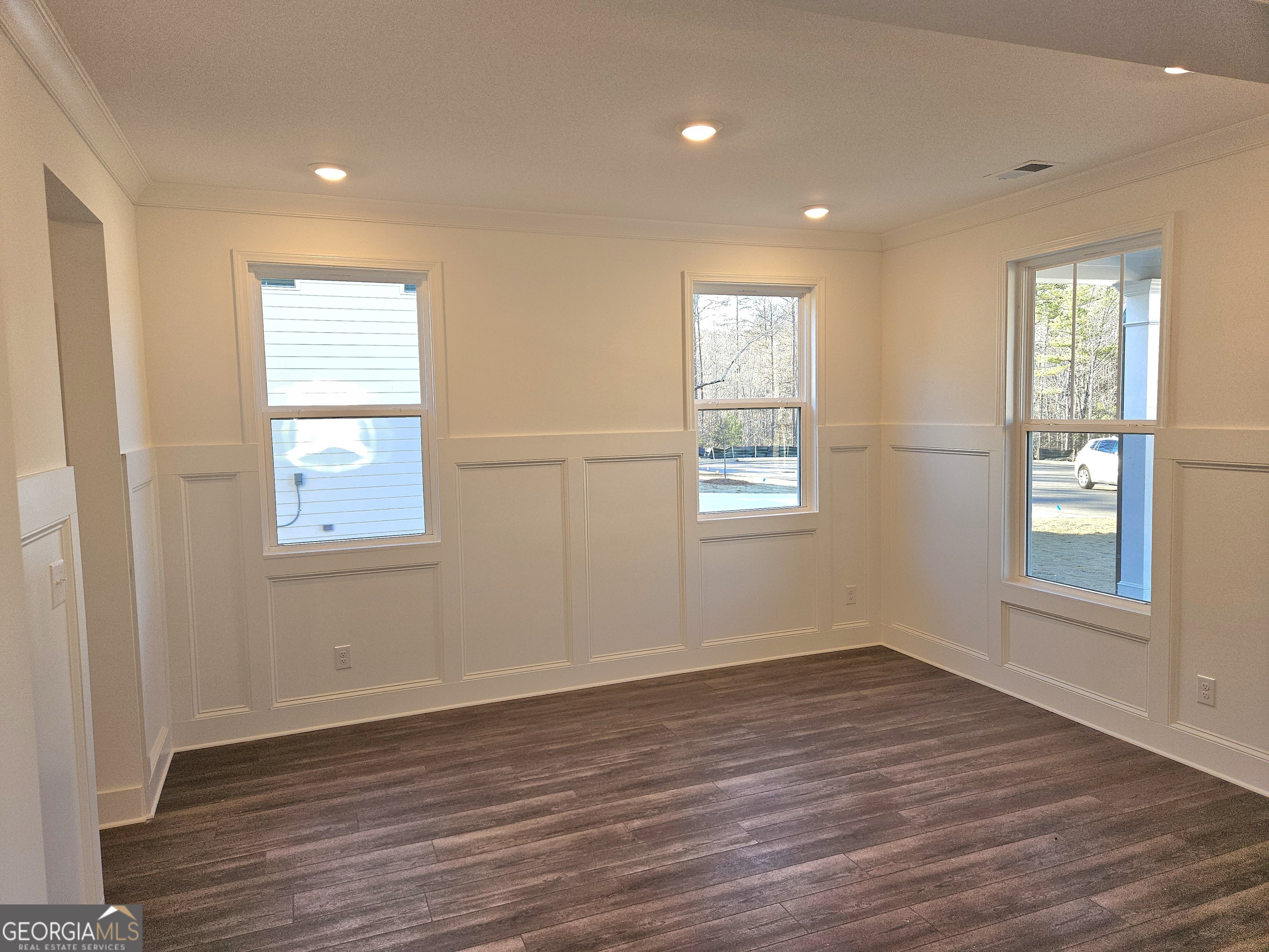 219 Andalusa Court Dallas, GA 30132 - Photo 7 of 50 an empty room with wooden floor and windows