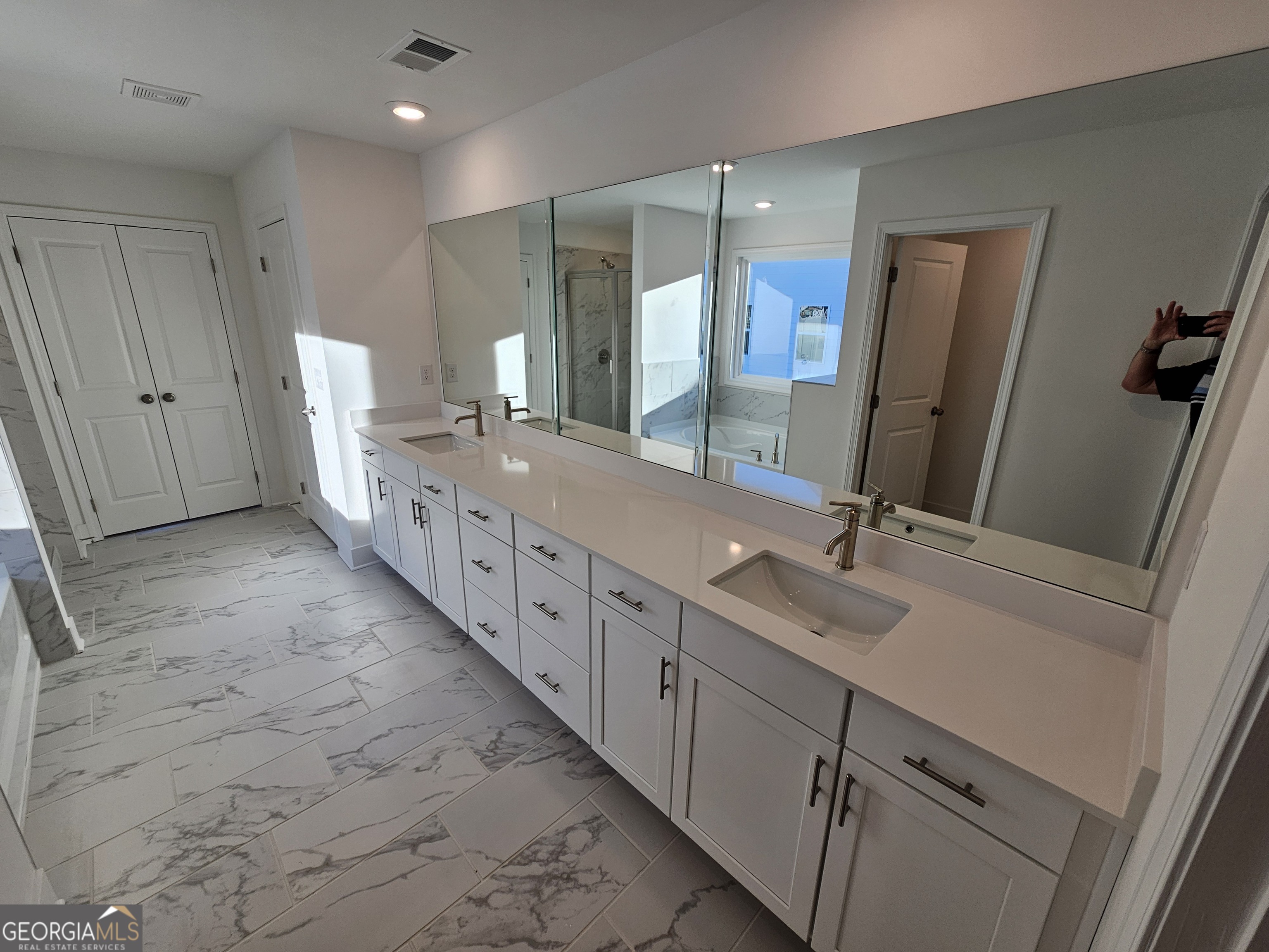 219 Andalusa Court Dallas, GA 30132 - Photo 9 of 50 a spacious bathroom with double vanity and mirrors